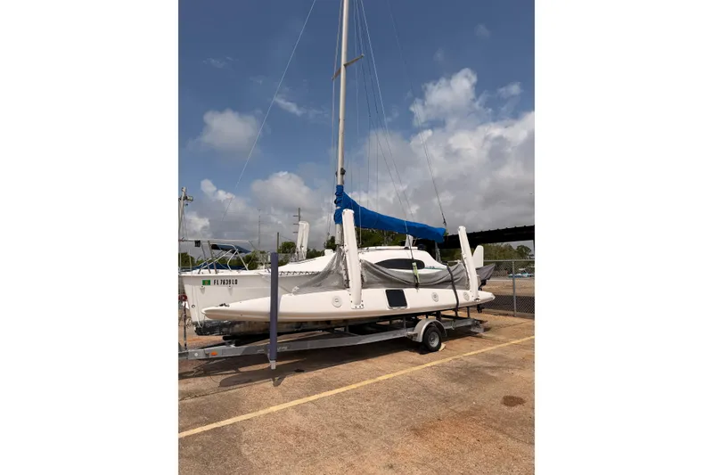 Slide: The Image of Corsair F-24 MkII trimaran sailboat on trailer, 2000 model, under a partly cloudy sky. - 3