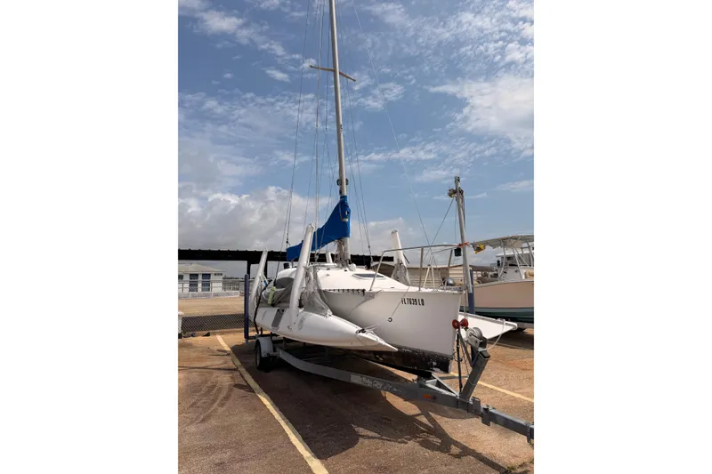 Slide: The Image of Corsair F-24 MkII trimaran sailboat on trailer, 2000 model, under a partly cloudy sky. - 5