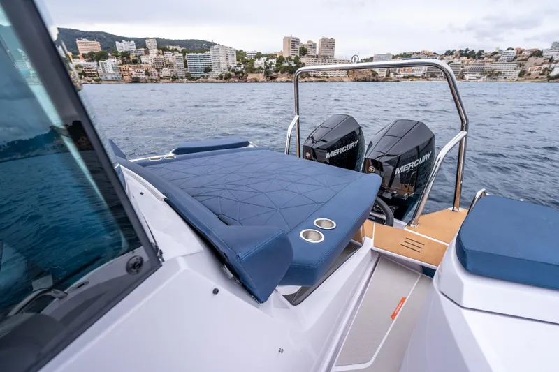 Slide: The Image of 2026 Axopar 29 XC Cross Cabin boat with dual Mercury engines on a scenic waterfront. - 9