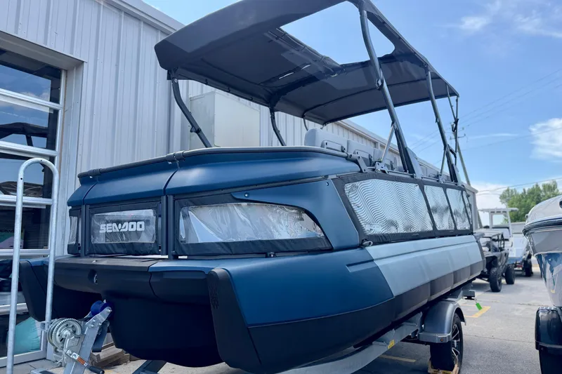 The Image of 2026 Sea-Doo Switch Cruise Limited 21 pontoon boat with canopy, parked outdoors. - 0