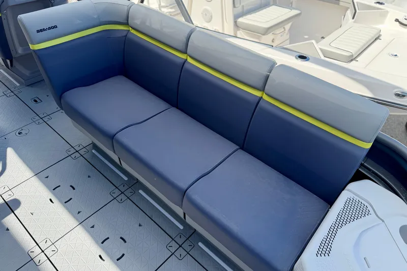 Slide: The Image of 2026 Sea-Doo Switch Cruise Limited 21 boat seating, featuring blue and gray upholstery with yellow accents. - 3