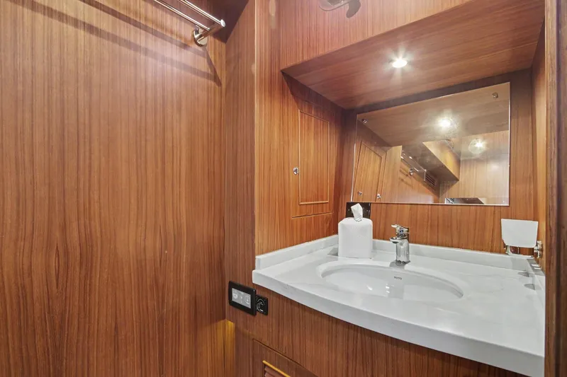 Slide: The Image of Luxurious bathroom in 2022 North Pacific 45 Pilothouse yacht with wood paneling and modern fixtures. - 30