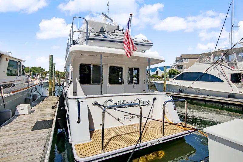 Slide: The Image of 2022 North Pacific 45 Pilothouse yacht docked at marina, rear view. - 7
