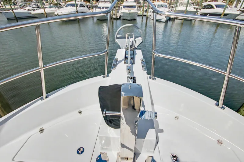 Slide: The Image of Bow view of 2022 North Pacific 45 Pilothouse yacht docked at marina. - 34