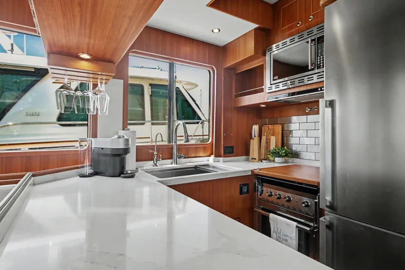 Slide: The Image of Modern kitchen interior of 2022 North Pacific 45 Pilothouse yacht with sleek appliances. - 13