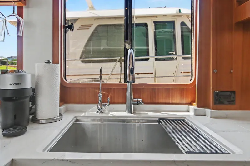 Slide: The Image of Modern kitchen sink in 2022 North Pacific 45 Pilothouse yacht interior. - 15