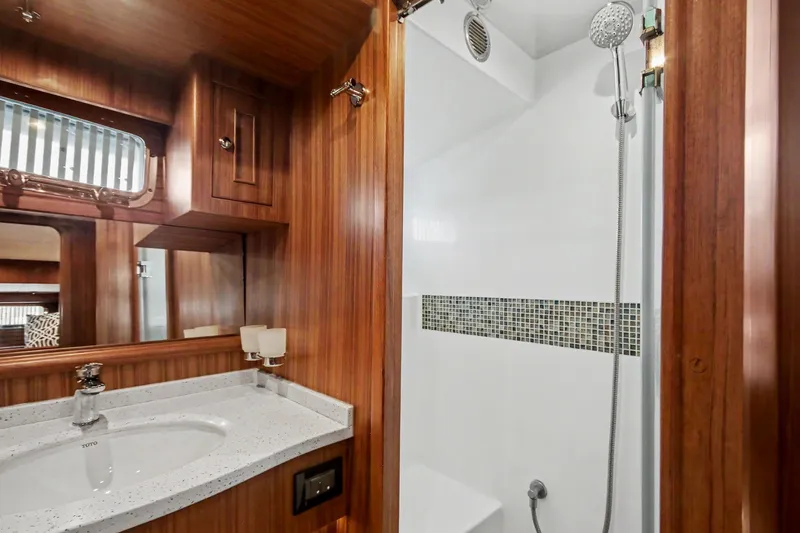 Slide: The Image of Luxurious bathroom in 2022 North Pacific 45 Pilothouse yacht with wood accents and modern fixtures. - 22