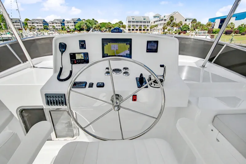 Slide: The Image of Pilothouse of 2022 North Pacific 45, featuring modern navigation equipment and steering wheel. - 39
