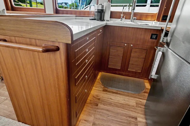Slide: The Image of Luxurious wooden interior of 2022 North Pacific 45 Pilothouse yacht kitchen. - 18