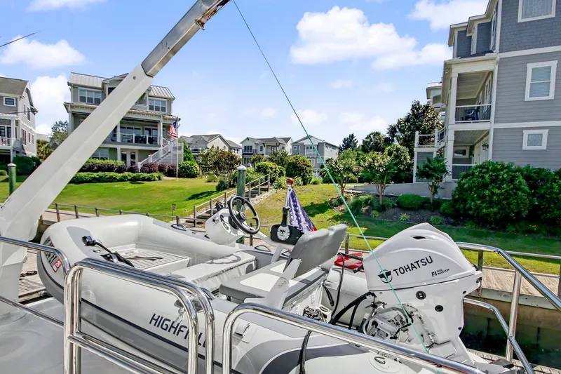 Slide: The Image of 2022 North Pacific 45 Pilothouse with Tohatsu motor docked near waterfront homes. - 41