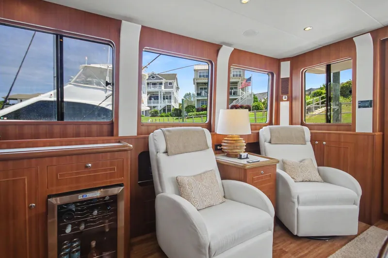 Slide: The Image of Luxurious interior of 2022 North Pacific 45 Pilothouse with plush seating and elegant wood finishes. - 11