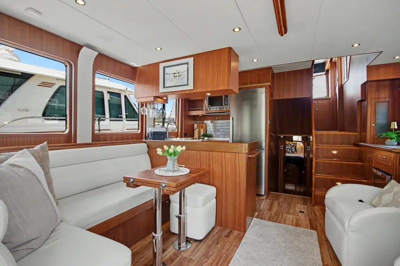 Slide: The Image of Luxurious interior of 2022 North Pacific 45 Pilothouse yacht with elegant wood finishes. - 1