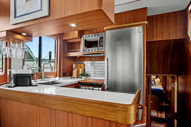 Slide: The Image of Luxurious kitchen interior of 2022 North Pacific 45 Pilothouse yacht with modern appliances. - 17