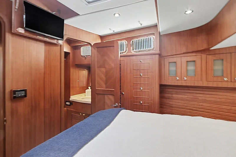 Slide: The Image of Luxurious interior of 2022 North Pacific 45 Pilothouse yacht with wood finish and modern amenities. - 29