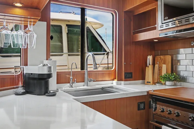 Slide: The Image of Modern kitchen interior of 2022 North Pacific 45 Pilothouse yacht with sleek design. - 14