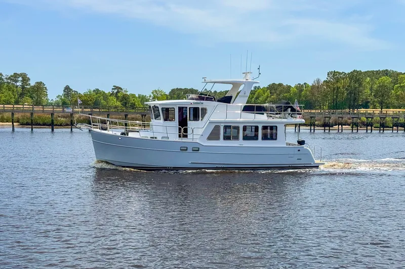 The Image of 2022 North Pacific 45 Pilothouse yacht cruising on a calm river. - 0