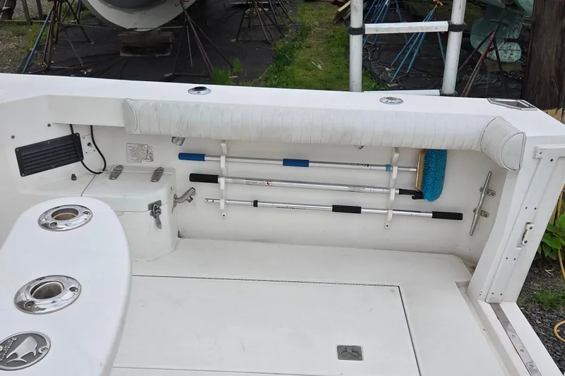Slide: The Image of 1999 Cabo 35 Express boat deck with storage and cleaning tools. - 10