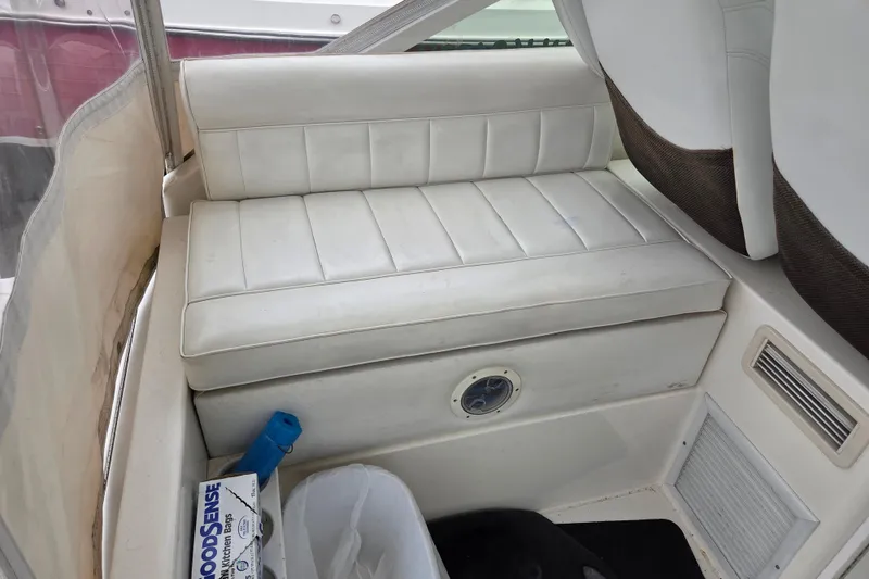 Slide: The Image of White cushioned seating on a 1999 Cabo 35 Express boat interior. - 15