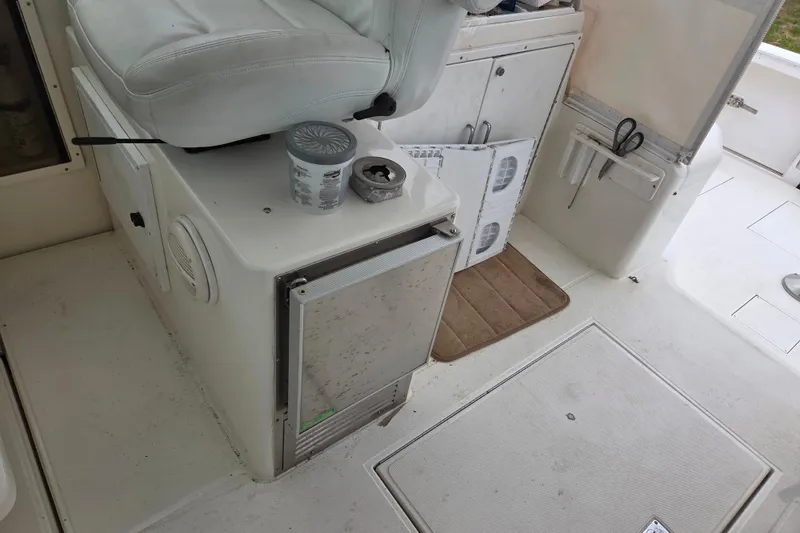 Slide: The Image of 1999 Cabo 35 Express boat interior with seating, storage, and equipment. - 17