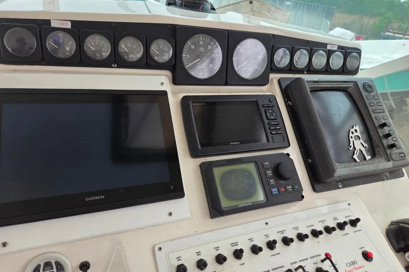 Slide: The Image of Control panel of a 1999 Cabo 35 Express boat with navigation instruments. - 21