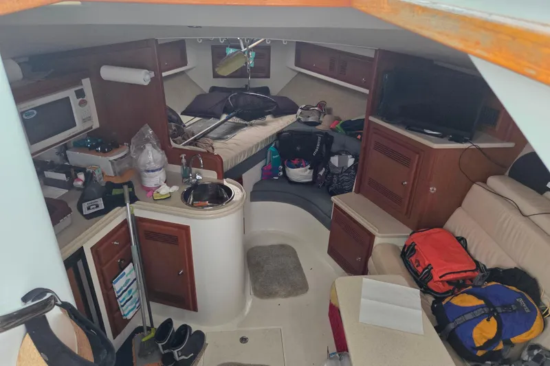 Slide: The Image of Interior of a 1999 Cabo 35 Express boat with kitchen and seating area. - 25