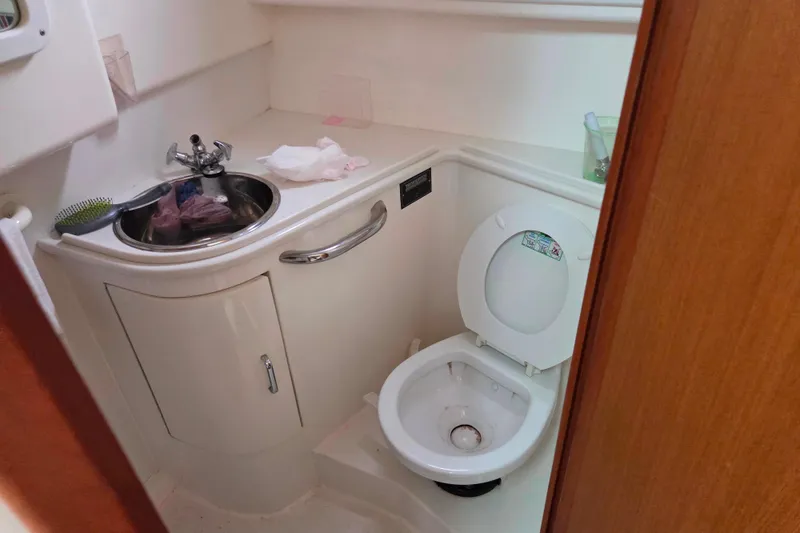 Slide: The Image of 1999 Cabo 35 Express boat bathroom with sink and toilet. - 28