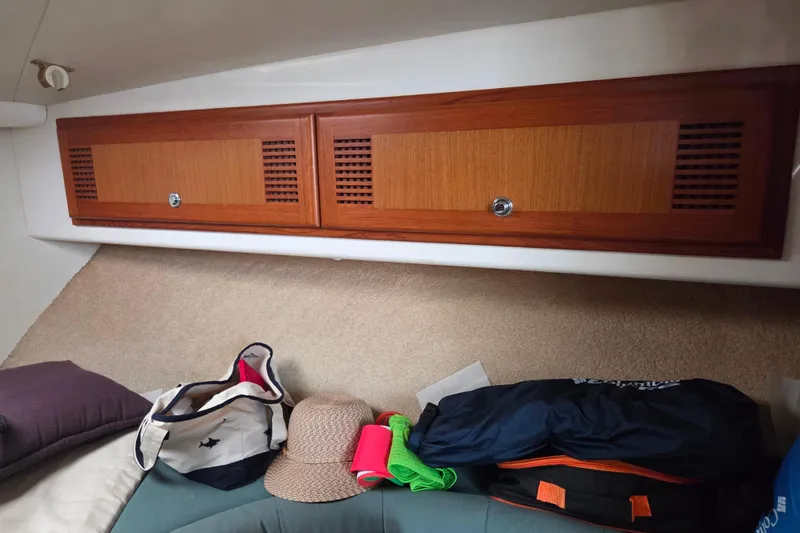 Slide: The Image of Interior of a 1999 Cabo 35 Express boat with wooden cabinets and assorted items. - 30