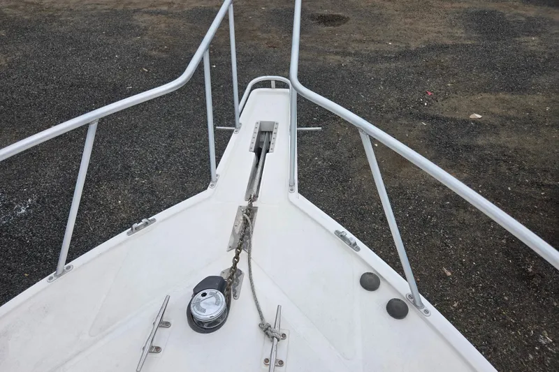 Slide: The Image of Bow of a 1999 Cabo 35 Express boat with anchor chain and railing. - 34