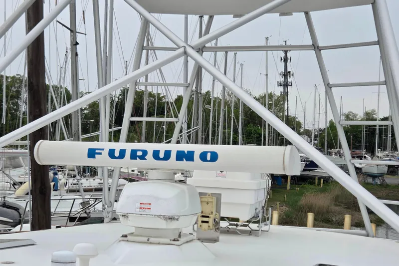 Slide: The Image of Radar equipment on a 1999 Cabo 35 Express boat in a marina setting. - 36