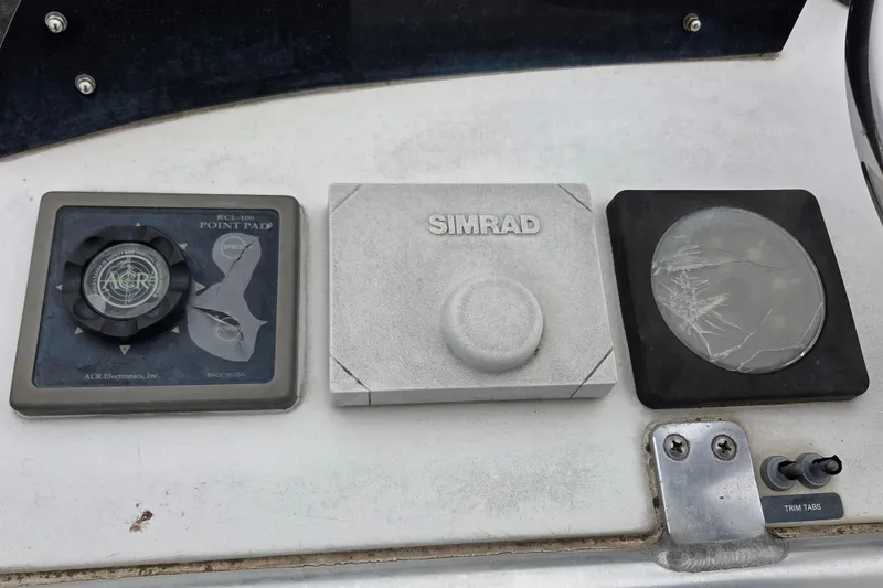 Slide: The Image of Control panel on a 1999 Cabo 35 Express boat with ACR and Simrad devices. - 41