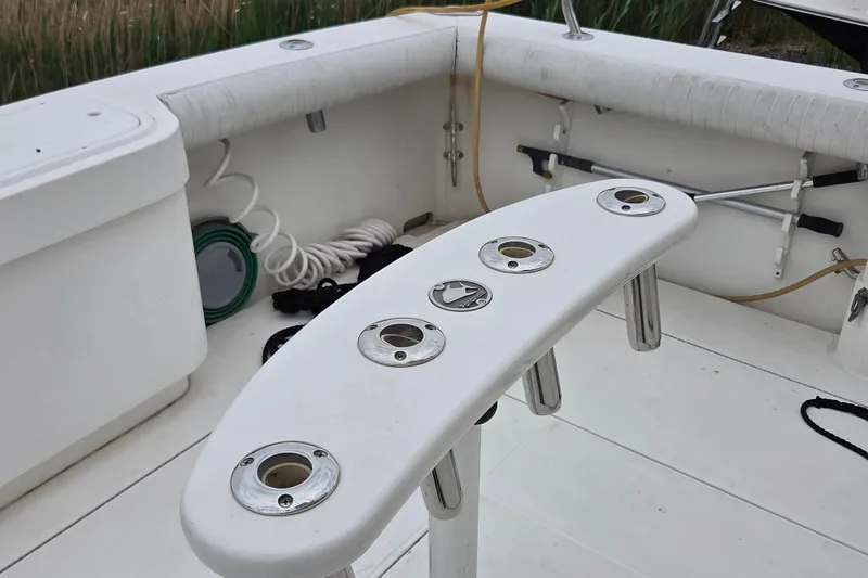 Slide: The Image of 1999 Cabo 35 Express boat cockpit with rod holders and fishing gear. - 7