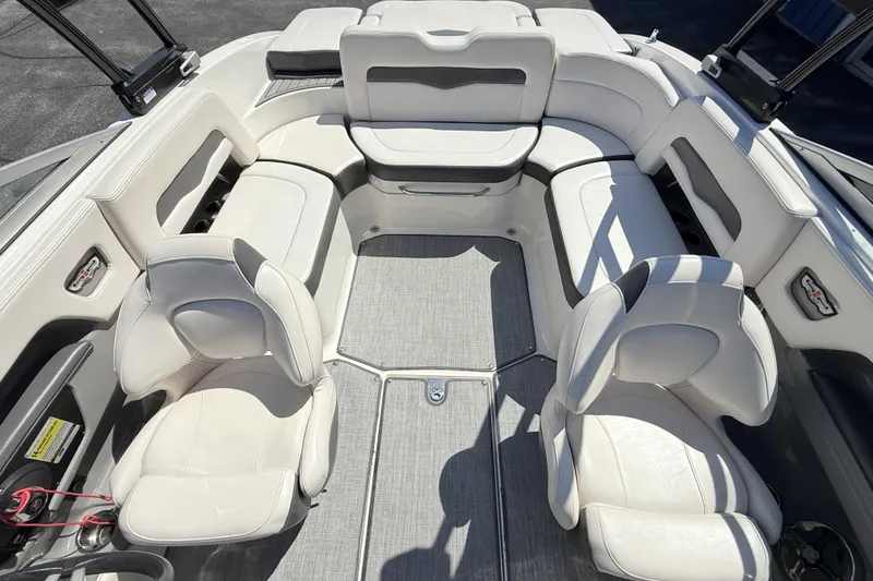 Slide: The Image of Interior of 2016 Chaparral 246 SSi boat with white seating and gray flooring. - 12
