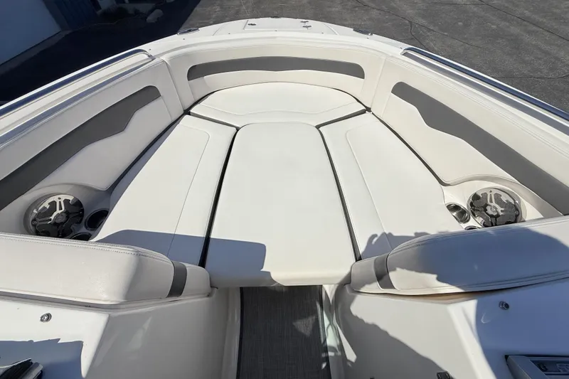 Slide: The Image of 2016 Chaparral 246 SSi boat interior with white seating and built-in speakers. - 13