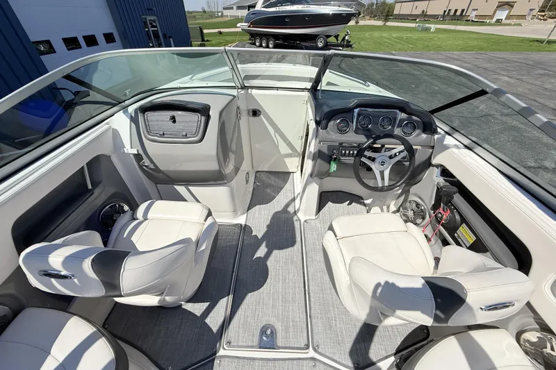 Slide: The Image of Interior view of 2016 Chaparral 246 SSi boat with white seating and dashboard. - 14