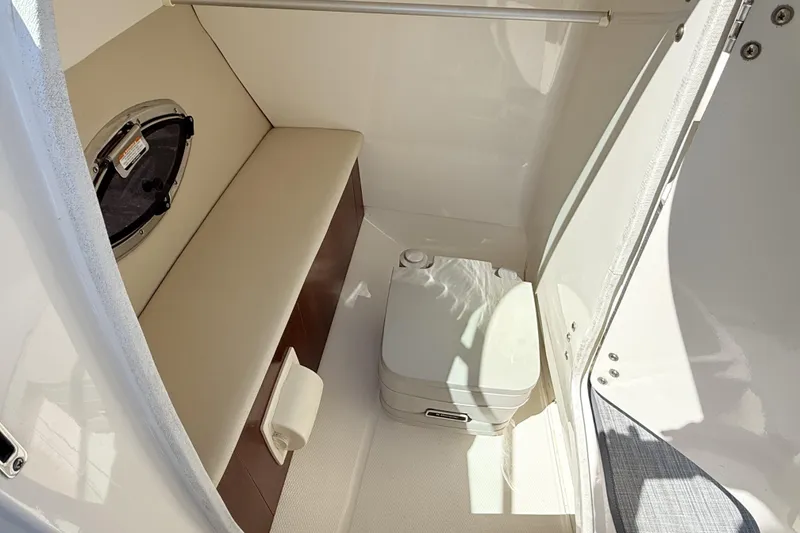 Slide: The Image of 2016 Chaparral 246 SSi boat interior with seating and portable toilet. - 17