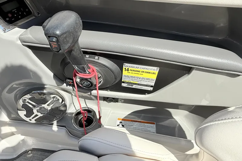 Slide: The Image of 2016 Chaparral 246 SSi boat interior with gear shift and capacity label. - 18