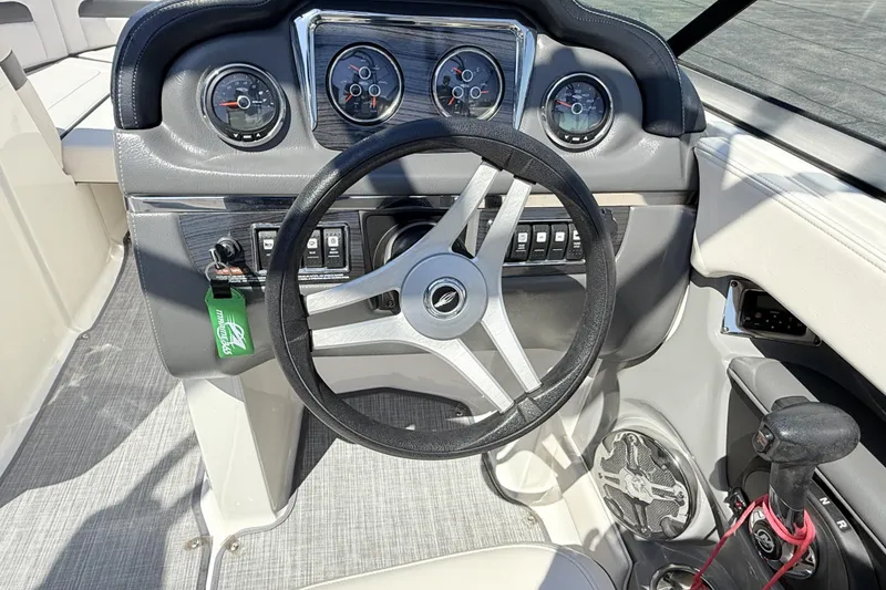 Slide: The Image of Steering wheel and dashboard of a 2016 Chaparral 246 SSi boat. - 19