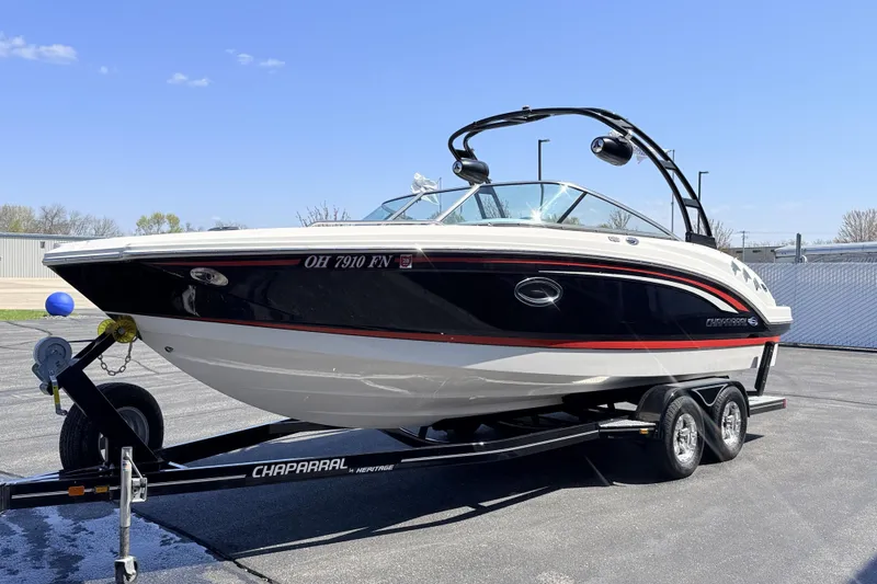 Slide: The Image of 2016 Chaparral 246 SSi boat on trailer, parked outdoors under clear sky. - 2