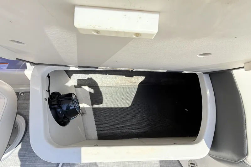 Slide: The Image of Open storage compartment in 2016 Chaparral 246 SSi boat interior. - 23