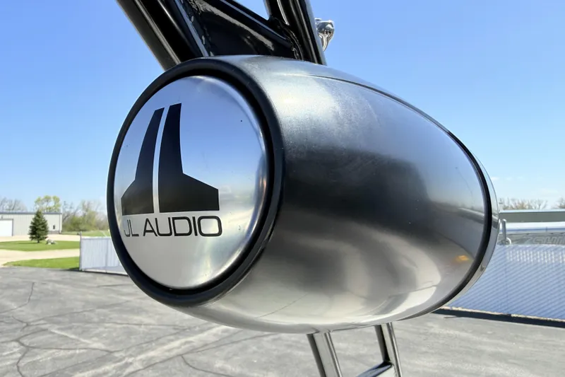 Slide: The Image of JL Audio speaker on 2016 Chaparral 246 SSi boat, outdoor setting. - 25