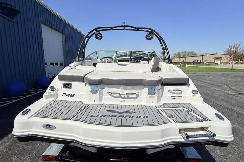 Slide: The Image of 2016 Chaparral 246 SSi boat, rear view, parked outdoors near a blue building. - 5