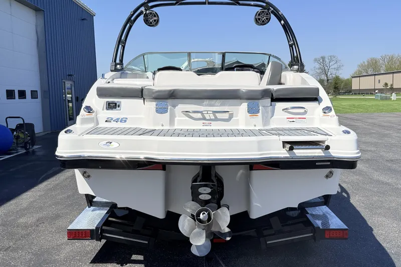 Slide: The Image of 2016 Chaparral 246 SSi boat, rear view, parked outdoors on a sunny day. - 6