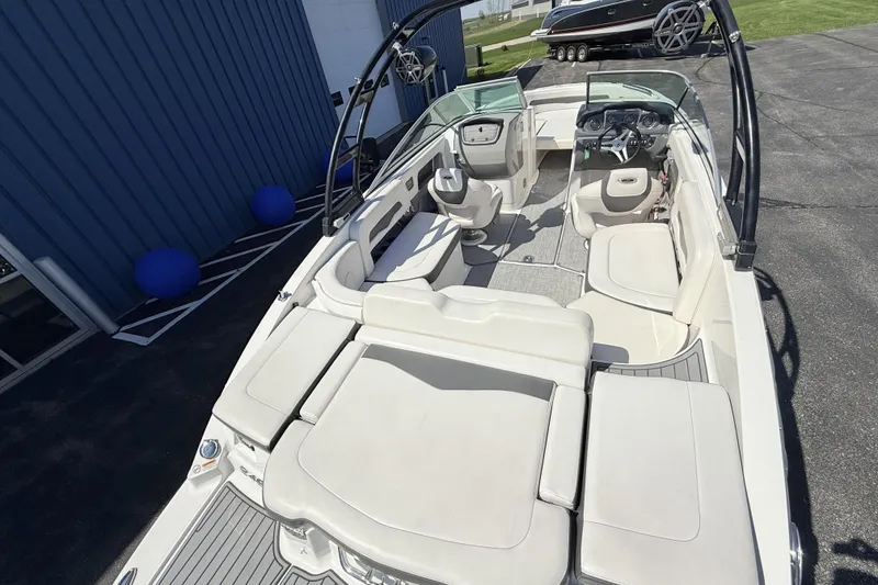 Slide: The Image of 2016 Chaparral 246 SSi boat interior with white seating and modern dashboard. - 8