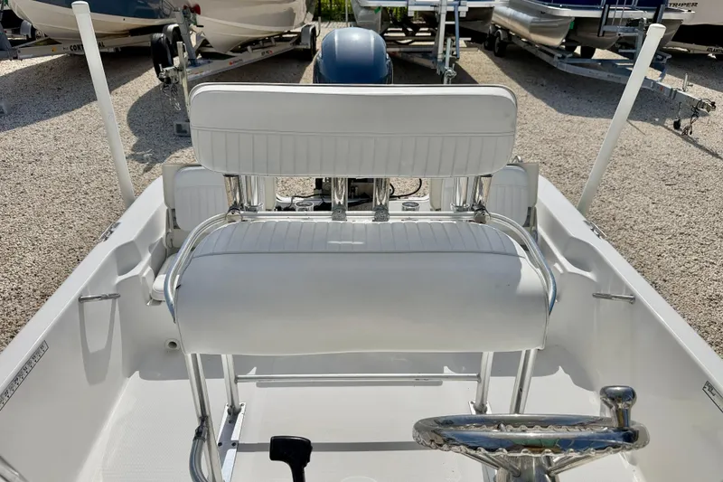Slide: The Image of 2010 NauticStar 2110 Nautic Bay boat interior with white seating and steering wheel. - 10