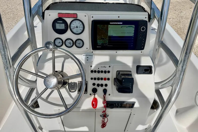 Slide: The Image of 2010 NauticStar 2110 Nautic Bay boat console with steering wheel and navigation instruments. - 12