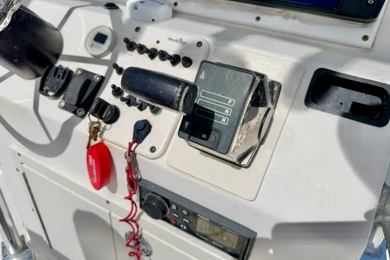 Slide: The Image of Control panel of a 2010 NauticStar 2110 Nautic Bay boat with throttle and switches. - 13