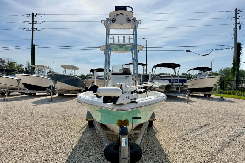 Slide: The Image of 2010 NauticStar 2110 Nautic Bay boat on trailer, surrounded by other boats in a lot. - 2