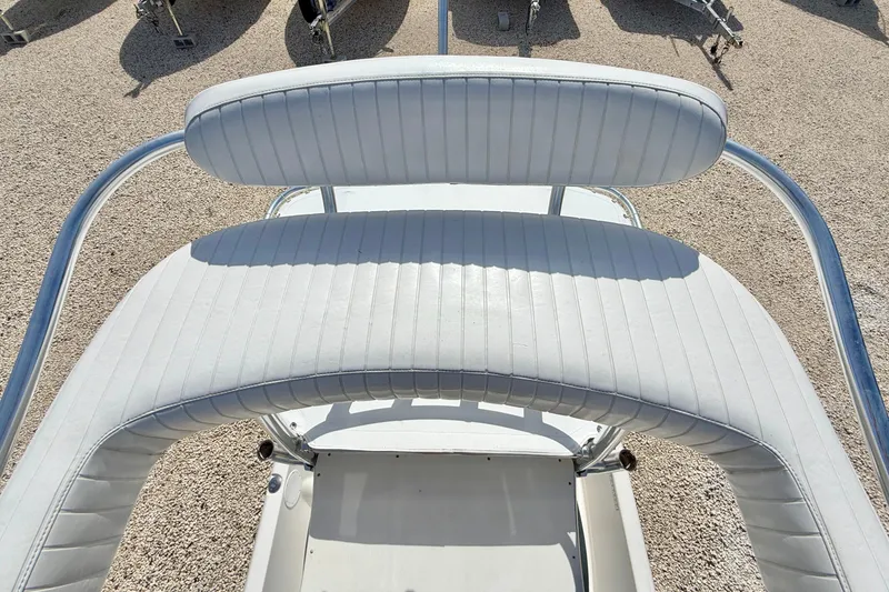 Slide: The Image of 2010 NauticStar 2110 Nautic Bay boat seating with white upholstery and metal frame. - 22
