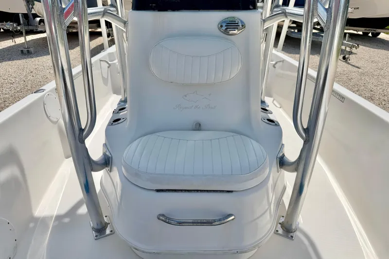 Slide: The Image of 2010 NauticStar 2110 Nautic Bay boat interior with white seating and stainless steel railings. - 23