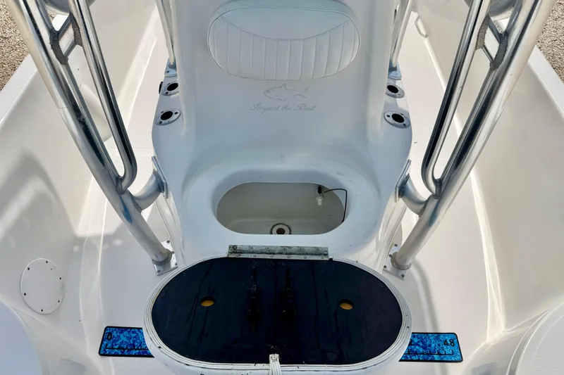 Slide: The Image of 2010 NauticStar 2110 Nautic Bay boat interior with seating and storage compartments. - 24